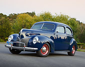 AUT 20 RK0658 01
1940 Mercury Tudor Dark Blue 3/4 Front View On Pavement By Trees