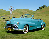 AUT 20 RK0660 01
1947 Oldsmobile Series 68 Convertible Caspian Blue 3/4 Front View On Grass By Old Windmill