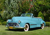 AUT 20 RK0661 01
1947 Oldsmobile Series 68 Convertible Caspian Blue 3/4 Front View On Grass By Trees