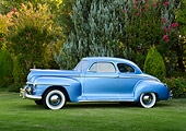 AUT 20 RK0662 01
1947 Plymouth Special Deluxe Coupe Blue Profile View On Grass By Trees