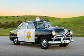 AUT 20 RK0666 01
1949 Ford Police Car 3/4 Front View On Pavement By Grassy Hills At Dusk