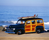 AUT 20 RK0006 03
1946 Ford Woody With Surfboards 3/4 Side View On Sand By Ocean