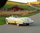 AUT 20 RK0089 01
1949 Buick Roadmaster Yellow Convertible 3/4 Rear View On Pavement By Barn