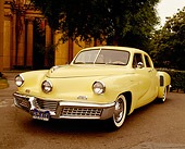 AUT 20 RK0104 04
1948 Tucker Yellow 3/4 Front View On Road With Trees And Columns