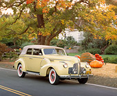 AUT 20 RK0202 04
1940 Buick Phaeton Limited Convertible Yellow 3/4 Front View On Road By Pumpkins