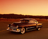 AUT 20 RK0214 03
1949 Cadillac Sedanette Dark Maroon 3/4 Front View On Pavement Filtered