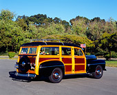 AUT 20 RK0247 01
1948 Ford Woody Station Wagon Black 3/4 Rear View On Pavement By Trees Background