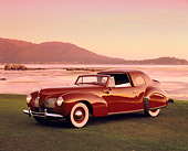 AUT 20 RK0253 03
1940 Lincoln Continental Convertible Coupe Red 3/4 Side View On Grass By Water