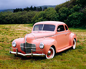 AUT 20 RK0269 03
1940 Dodge Business Coupe Peach 3/4 Front View On Grass Bushes Background