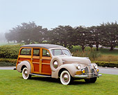 AUT 20 RK0278 02
1940 Pontiac Six Hercules Station Wagon Woodie Tan 3/4 Front View On Grass By Trees