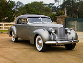 AUT 20 RK0324 01
1940 Packard Darrin Sedan Convertible Silver Front 3/4 View On Dirt By Fence Trees