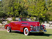 AUT 20 RK0358 01
1941 Cadillac Deluxe Convertible Oxblood Red 3/4 Front View On Grass By Trees