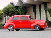 AUT 20 RK0369 01
1940 Ford 2-Door Sedan Red Profile View On Pavement By Building And Trees