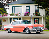 AUT 21 BK0019 01
1957 Pontiac Chieftain Coral And White 3/4 Front View On Pavement By House
