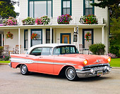 AUT 21 BK0020 01
1957 Pontiac Chieftain Coral And White 3/4 Front View On Pavement By House