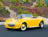 AUT 21 BK0024 01
1958 Austin-Healey Sprite (AKA Bugeye) Convertible Hot Rod Yellow 3/4 Front View On Pavement By Park