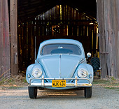 AUT 21 BK0029 01
1957 Volkswagen Beetle Light Blue Head On View On Gravel By Barn