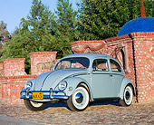 AUT 21 BK0031 01
1957 Volkswagen Beetle Light Blue 3/4 Front View On Cobblestone By Brick Wall