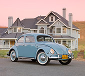 AUT 21 BK0034 01
1957 Volkswagen Beetle Light Blue 3/4 Front View On Pavement By House At Dusk