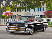 AUT 21 BK0037 01
1957 Chevrolet Bel Air Black 3/4 Front View On Pavement By White Fence And House