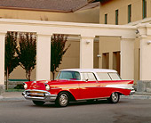 AUT 21 RK0046 09
1957 Chevy Nomad Wagon Red And White 3/4 Front Building In Background