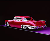 AUT 21 RK0139 12
1957 Candy Raspberry Cadillac Eldorado Kustom 3/4 Side Rear On Purple Floor Gray Line Studio Background