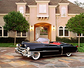 AUT 21 RK0273 09
1953 Cadillac Eldorado Convertible Black 3/4 Side In Front Of House Headlights On At Dusk
