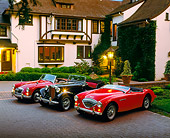 AUT 21 RK0289 04
1952 Black MG TD 54 Red Austin-Healey 62 Red MGA Mark 2 3/4 Side In Front Of House At Dusk