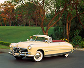 AUT 21 RK0447 05
1950 Hudson Commodore Convertible Yellow 3/4 Side View On Pavement By Trees And Grass