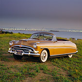 AUT 21 RK0859 01
1953 Hudson Hornet Convertible Gold 3/4 Front View On Dirt By Water At Dusk