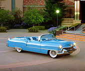 AUT 21 RK1070 03
1955 Cadillac Convertible Blue 3/4 Side View On Pavement Headlights On At Dusk