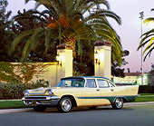 AUT 21 RK1117 01
1957 Desoto Firesweep Yellow And Green 3/4 Side View On Pavement By Palm Trees And Wall At Dusk
