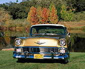 AUT 21 RK1133 01
1956 Chevy 2 Door Hardtop Cream And Gold Slight Side View On Grass By Water
