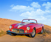 AUT 21 RK1342 02
1957 Maserati A6G/2000 Frua Spider Red With White Stripe 3/4 Front View On Dirt Hill Blue Sky