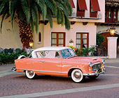AUT 21 RK1385 03
1955 AMC Nash Rambler Country Club Pink 3/4 Side View By Spanish Building And Palm Tree