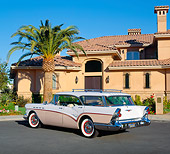 AUT 21 RK1549 02
1957 Buick Century Estate Wagon Pink And White 3/4 Rear View On Pavement By Building And Palm Tree