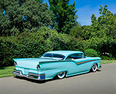 AUT 21 RK1644 03
1957 Ford Fairlane Custom Light Blue 3/4 Rear View On Pavement By Trees