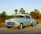 AUT 21 RK1668 04
1952 Chevy Bel Air Hardtop Beige 3/4 Front View On Pavement Trees Background At Dusk
