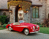 AUT 21 RK1677 02
1951 Jowett Jupiter Roadster Red 3/4 Side View On Driveway By House