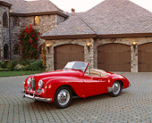 AUT 21 RK1681 02
1951 Jowett Jupiter Roadster Red 3/4 Front View On Driveway By Garage Doors