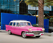 AUT 21 RK1688 03
1958 Studebaker Station Wagon Pink 3/4 Front View On Pavement By Palm Trees And Glass Building