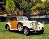 AUT 21 RK1796 03
1952 MG TD Boattail Roadster Ivory 3/4 Side View On Grass By Water