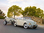 AUT 21 RK2409 01
1958 Volkswagen Beetle Convertible White And Gray 3/4 Front View On Pavement By Stone Wall Towing Scale Model