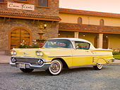 AUT 21 RK2431 01
1958 Chevrolet Impala Yellow 3/4 Front View On Gravel By Building