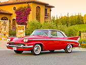 AUT 21 RK2457 01
1958 Packard Red 3/4 Front View On Pavement By House