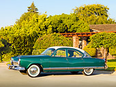 AUT 21 RK2472 01
1954 Kaiser Manhattan Green And Cream 3/4 Front View On Pavement By House And Shrubs