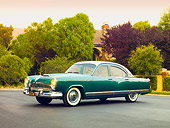 AUT 21 RK2476 01
1954 Kaiser Manhattan Green And Cream 3/4 Front View On Pavement By House And Shrubs