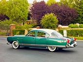 AUT 21 RK2477 01
1954 Kaiser Manhattan Green And Cream 3/4 Rear View On Pavement By House And Shrubs