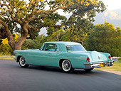 AUT 21 RK2485 01
1956 Lincoln Continental Mark II Light Green 3/4 Rear View On Pavement By Trees