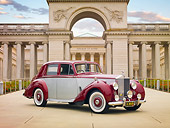 AUT 21 RK2506 01
1954 Rolls-Royce Silver Dawn Silver And Maroon 3/4 Front View On Pavement By Building